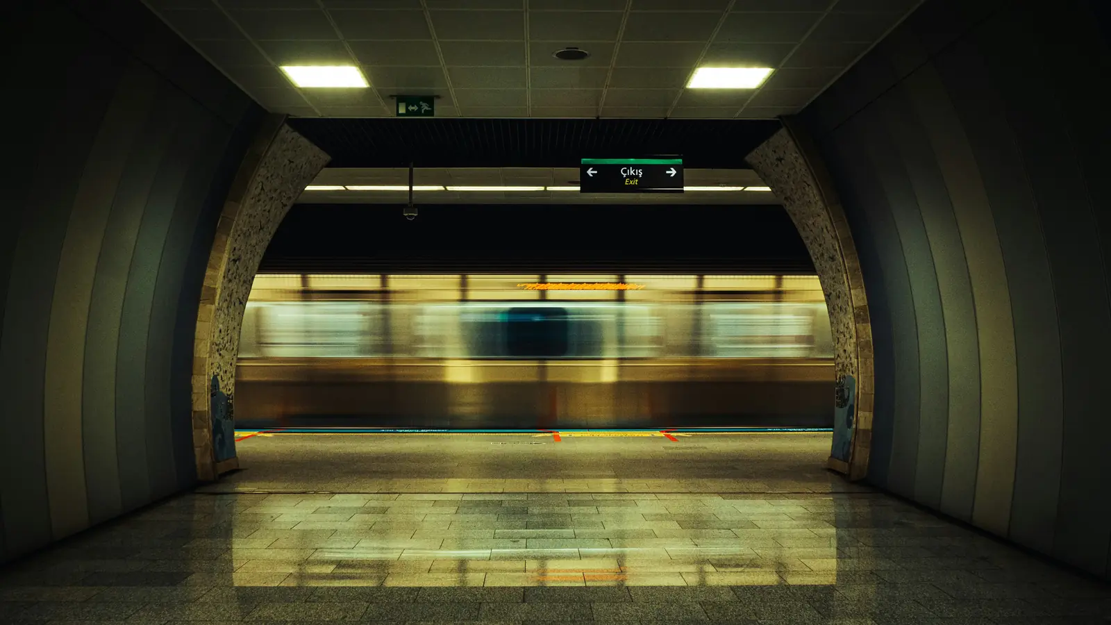 A metro train moving fast through a station in Istanbul